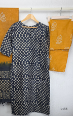 Navy blue chanderi silk churidar set with all-over cream polka dot block print, straight cut kurti with round neck and 3/4 sleeves, paired with plain mustard churidar bottom and mustard-navy dual-tone block print dupatta with tassel border, Indian ethnic wear from Beleza Calicut