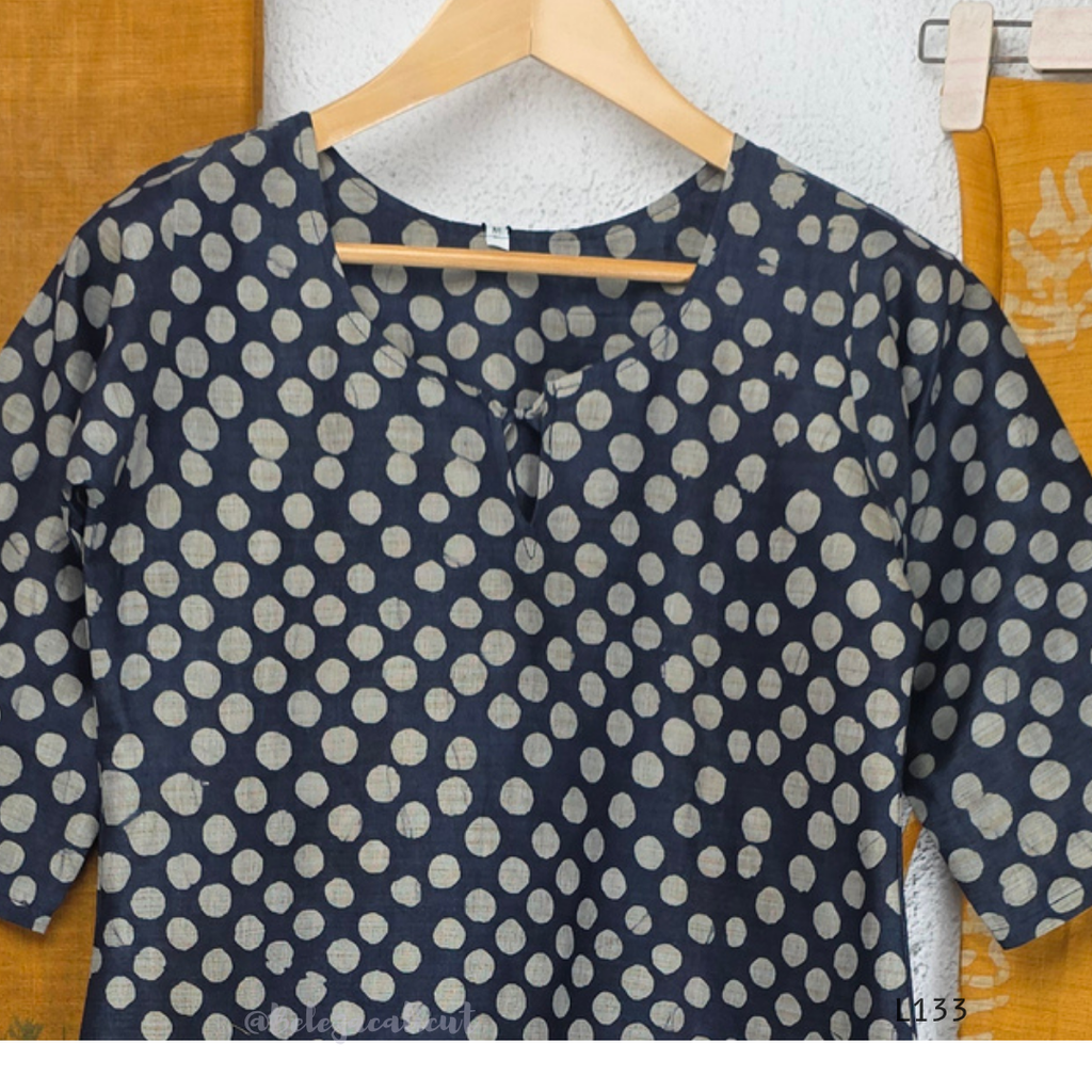 Navy blue chanderi silk churidar set with all-over cream polka dot block print, straight cut kurti with round neck and 3/4 sleeves, paired with plain mustard churidar bottom and mustard-navy dual-tone block print dupatta with tassel border, Indian ethnic wear from Beleza Calicut