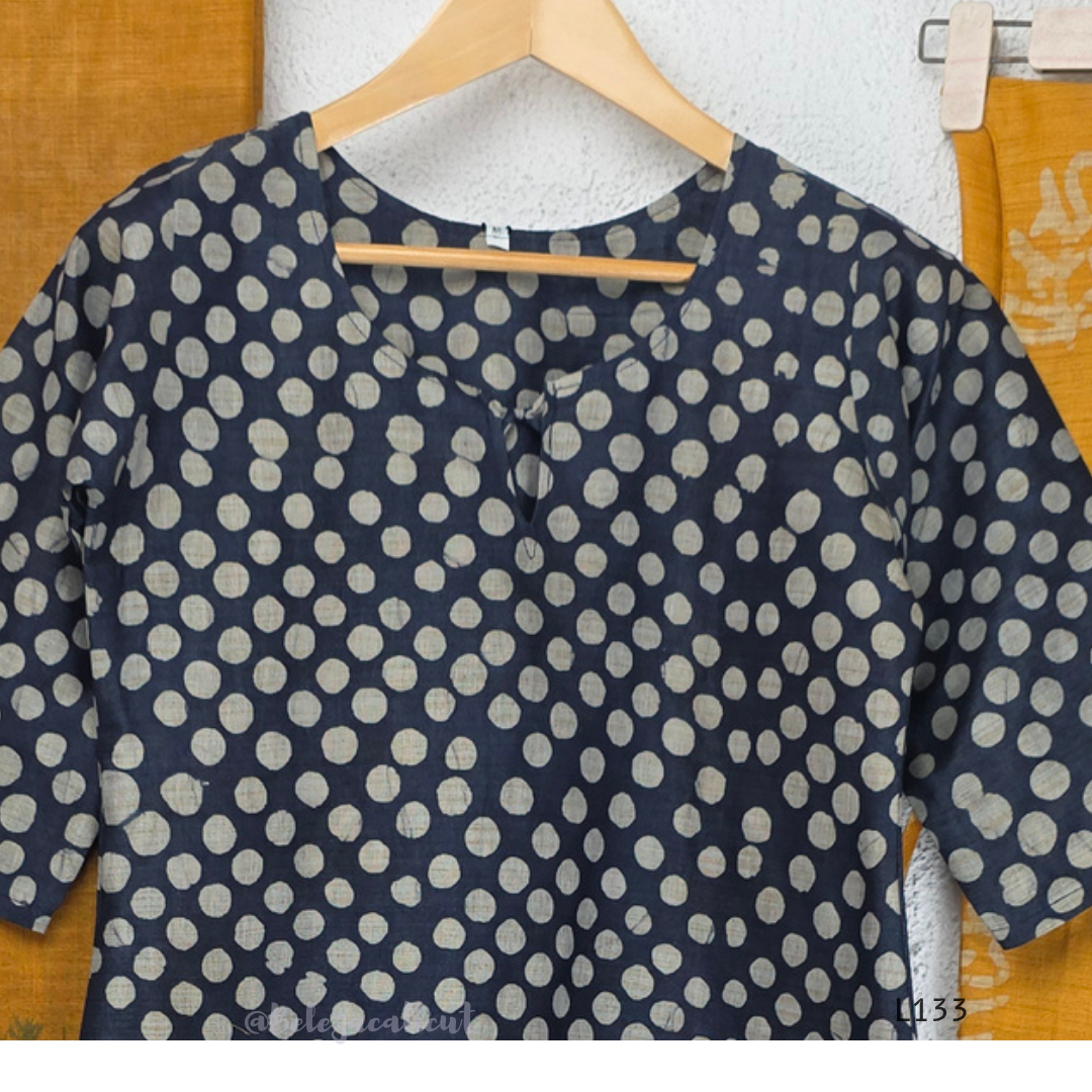 Navy blue chanderi silk churidar set with all-over cream polka dot block print, straight cut kurti with round neck and 3/4 sleeves, paired with plain mustard churidar bottom and mustard-navy dual-tone block print dupatta with tassel border, Indian ethnic wear from Beleza Calicut