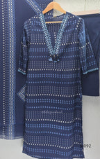 Deep navy blue cotton-blend churidar set with geometric print, embroidered V-neckline, plain wide straight bottom and printed dupatta.