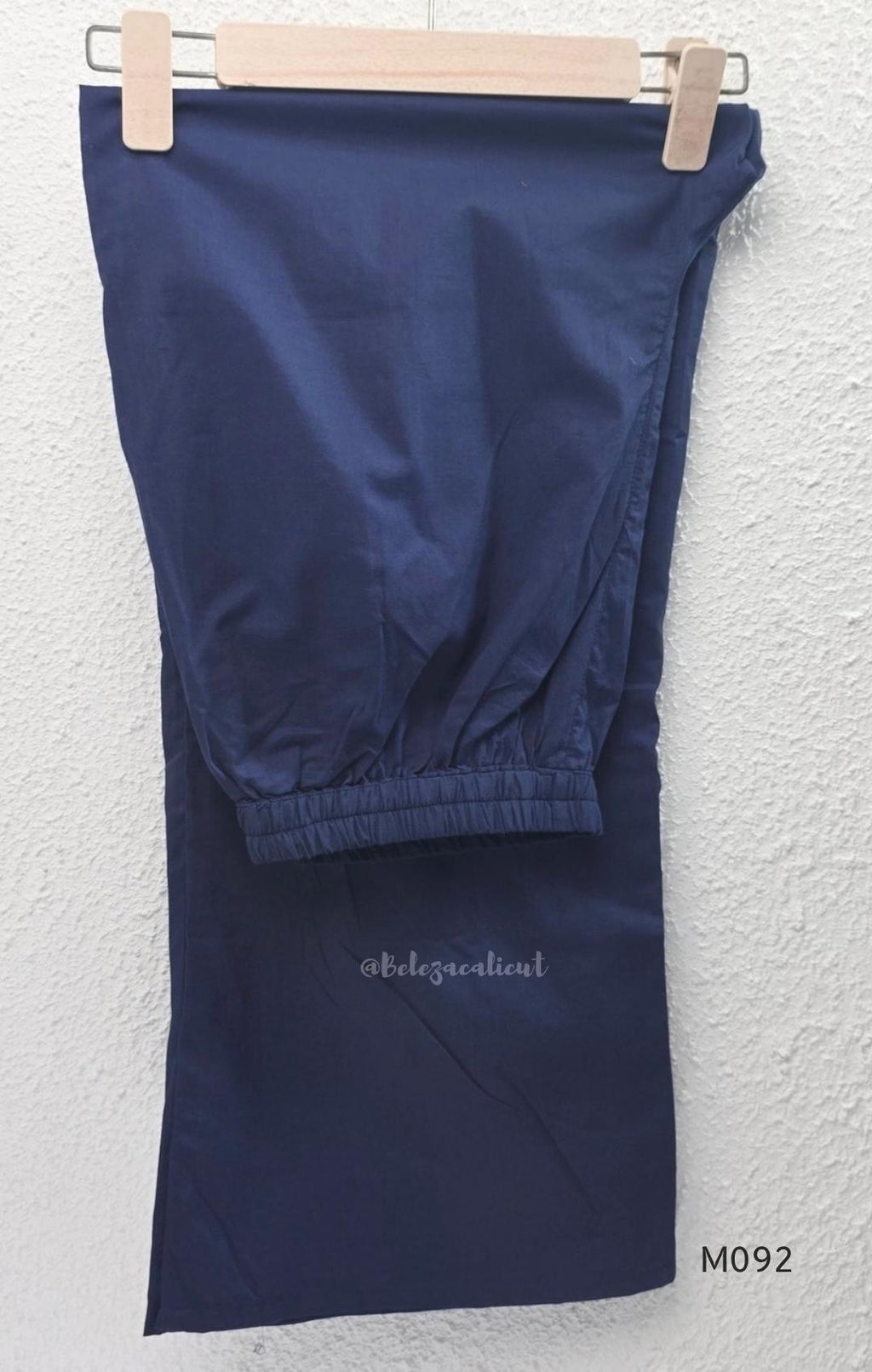 Deep navy blue cotton-blend churidar set with geometric print, embroidered V-neckline, plain wide straight bottom and printed dupatta.