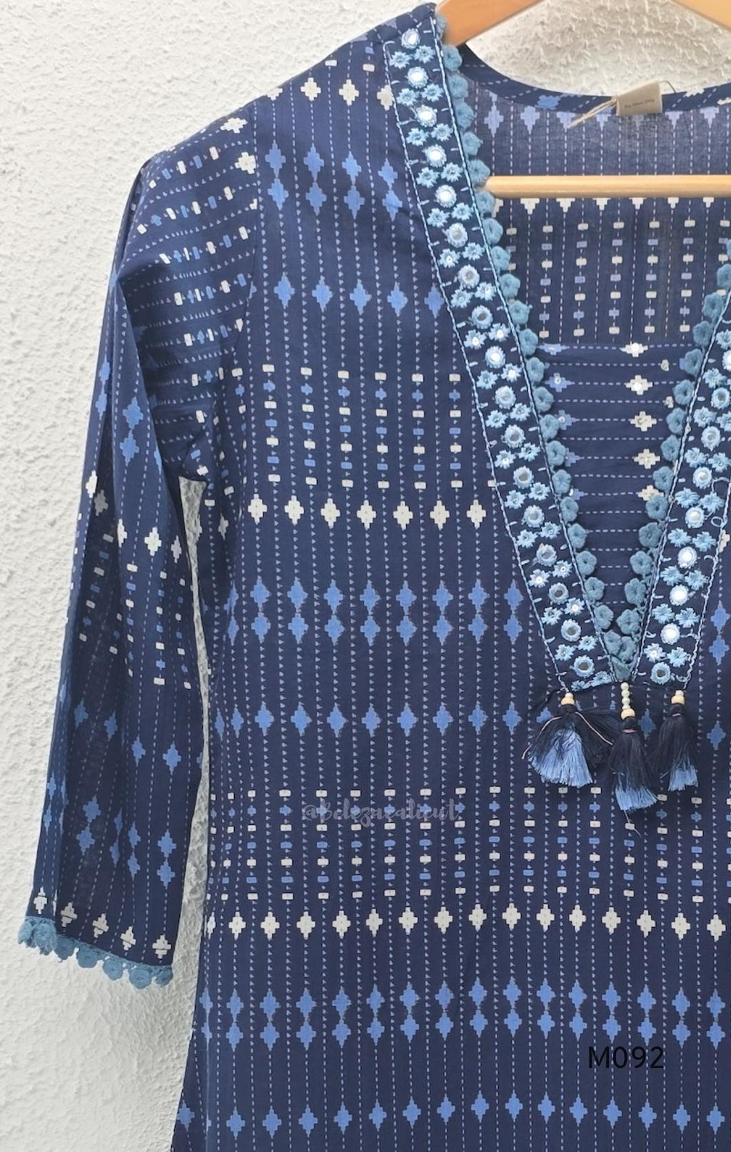 Deep navy blue cotton-blend churidar set with geometric print, embroidered V-neckline, plain wide straight bottom and printed dupatta.