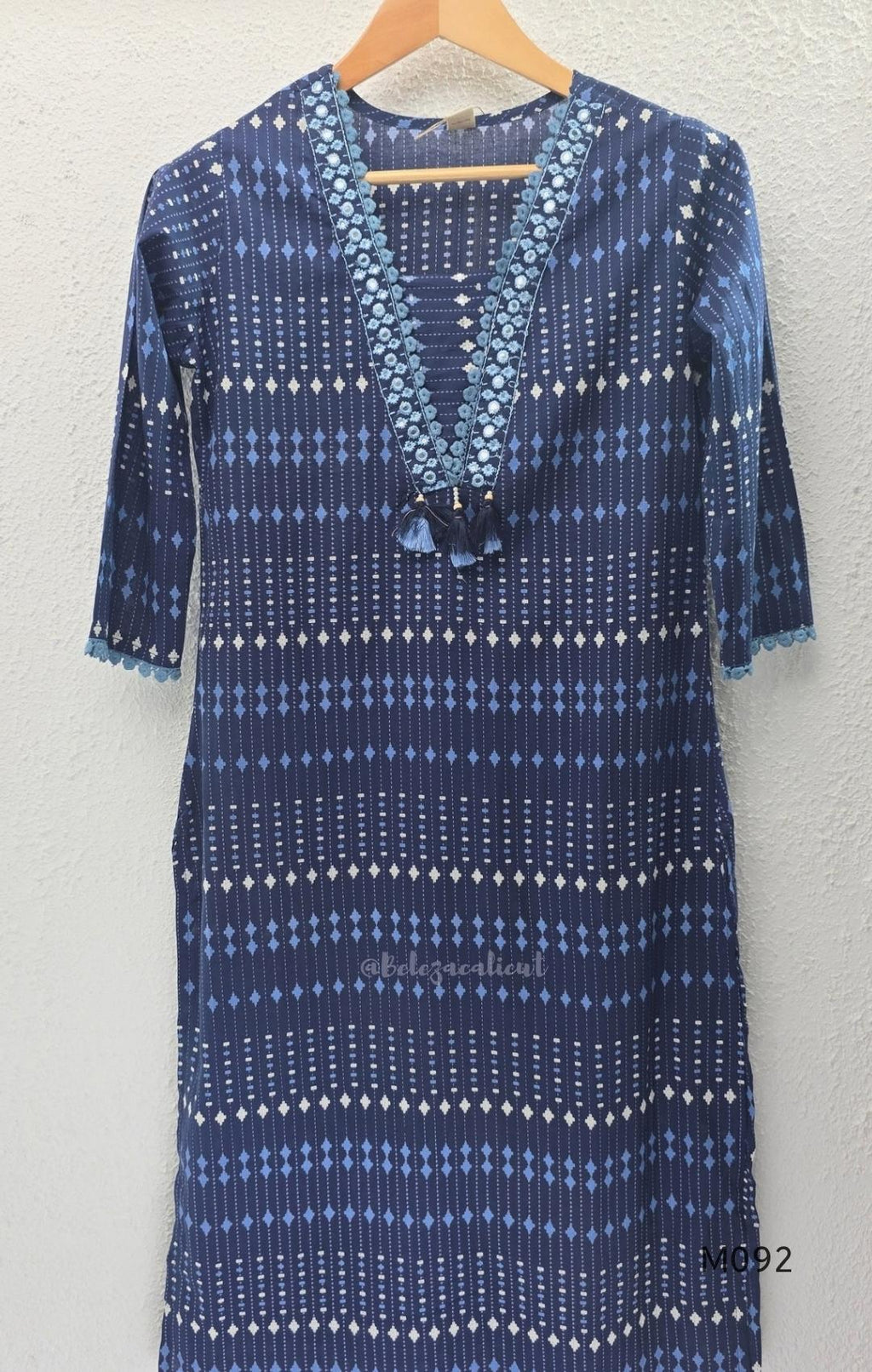 Deep navy blue cotton-blend churidar set with geometric print, embroidered V-neckline, plain wide straight bottom and printed dupatta.