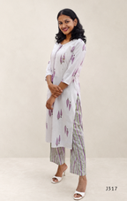 Off white cotton 2-piece kurti set with lavender leaf print, striped bottom, 3/4 sleeves, and tassel neckline worn by model.