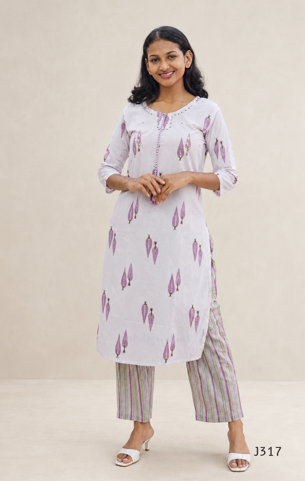 Off white cotton 2-piece kurti set with lavender leaf print, striped bottom, 3/4 sleeves, and tassel neckline worn by model.