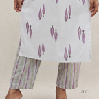 Off white cotton 2-piece kurti set with lavender leaf print, striped bottom, 3/4 sleeves, and tassel neckline worn by model.