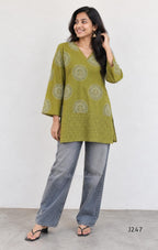 Olive green cotton short top with circular white and dark print and tonal cutwork-style lower panel.
