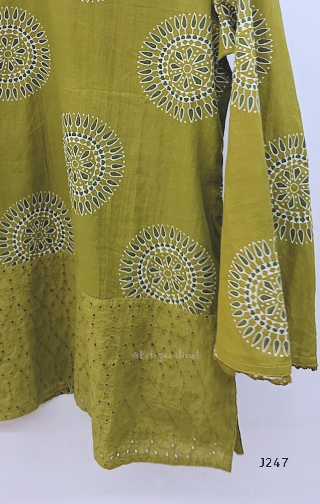 Olive green cotton short top with circular white and dark print and tonal cutwork-style lower panel.