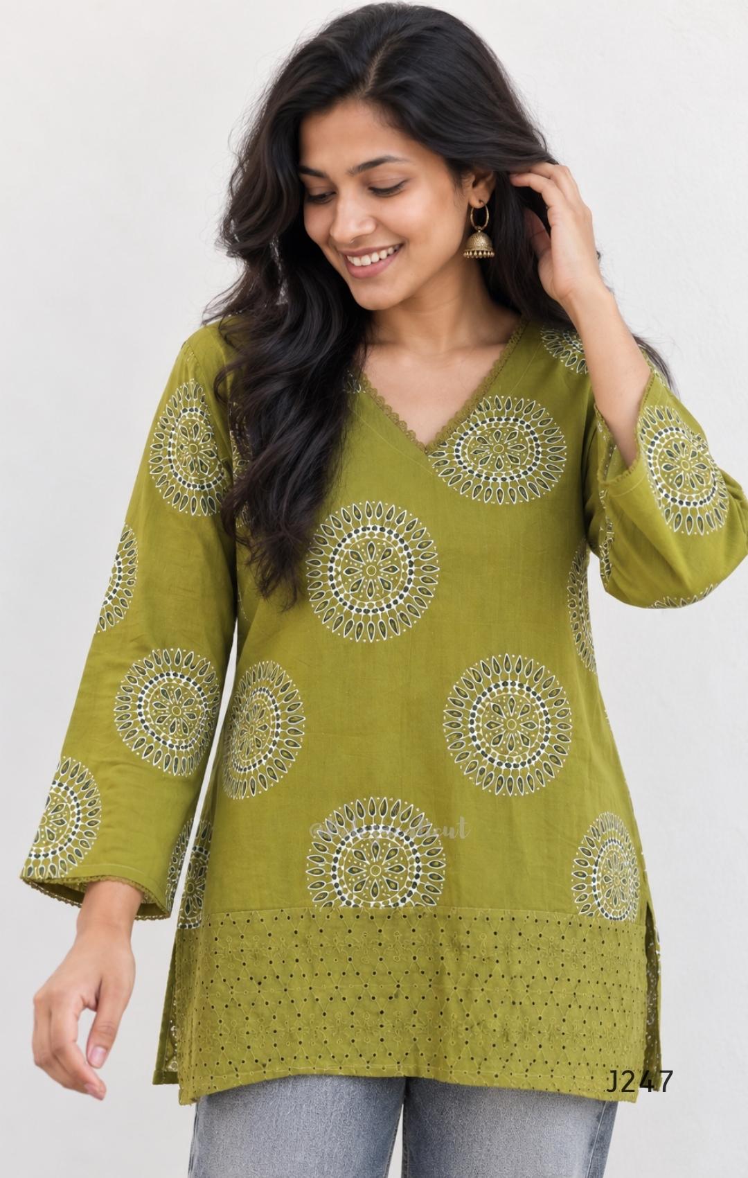 Olive green cotton short top with circular white and dark print and tonal cutwork-style lower panel.