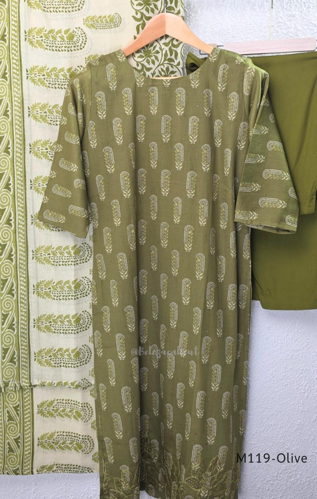 Olive green Cotton Silk churidar set with printed motifs, embroidered floral hem and cream-and-olive printed dupatta.