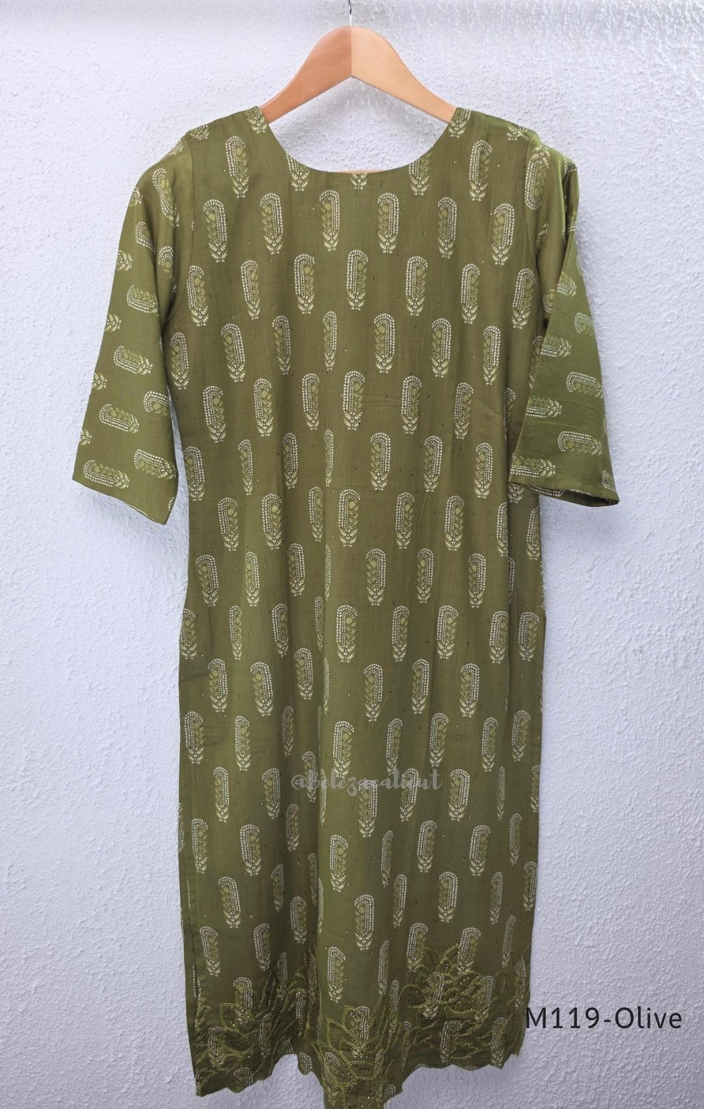 Olive green Cotton Silk churidar set with printed motifs, embroidered floral hem and cream-and-olive printed dupatta.