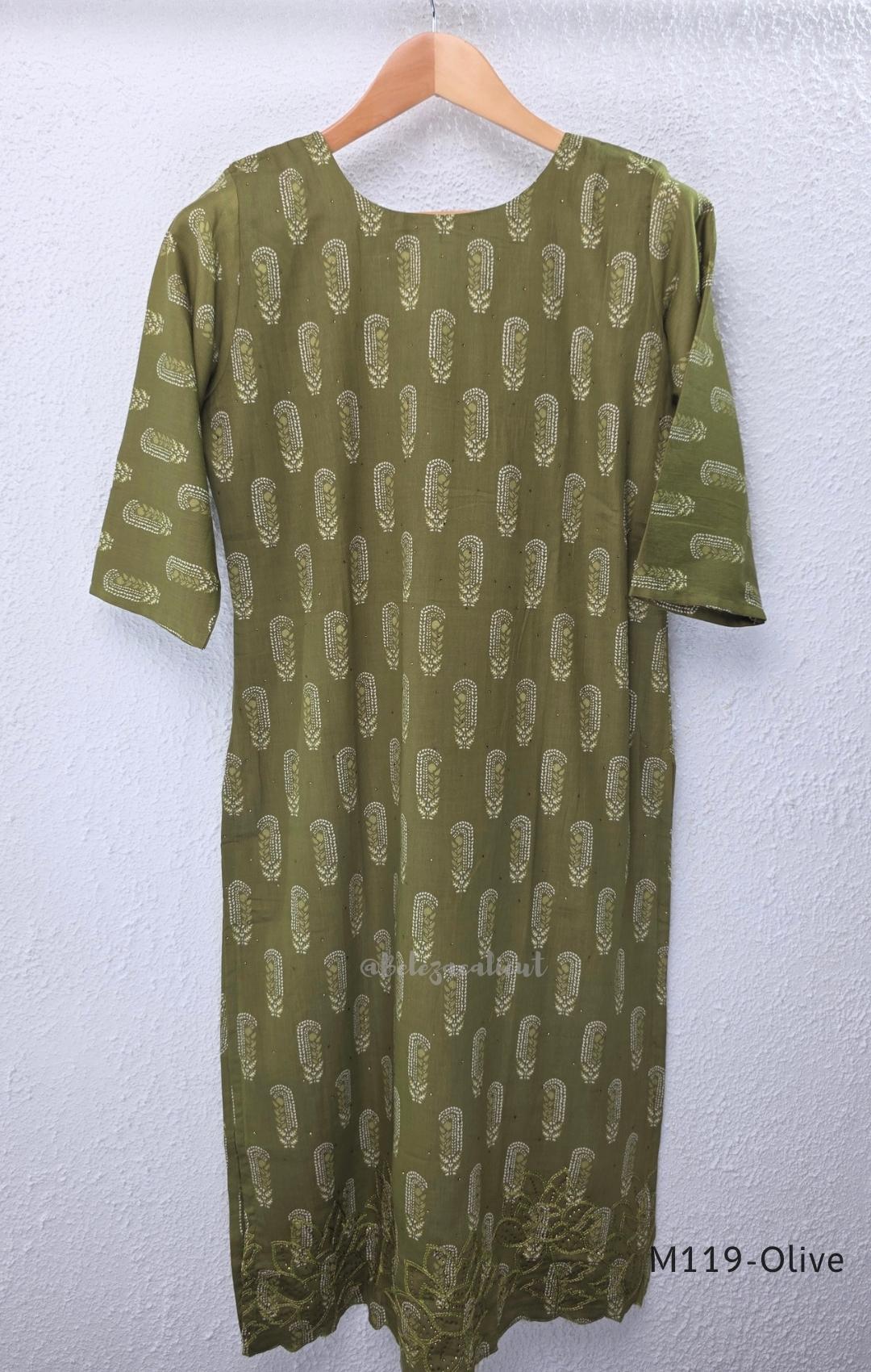 Olive green Cotton Silk churidar set with printed motifs, embroidered floral hem and cream-and-olive printed dupatta.