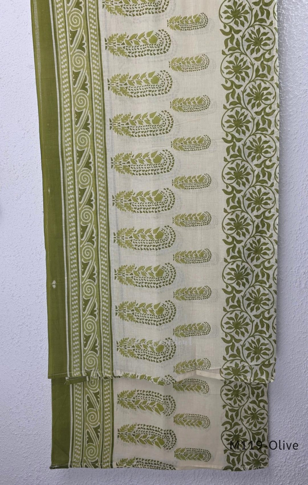 Olive green Cotton Silk churidar set with printed motifs, embroidered floral hem and cream-and-olive printed dupatta.