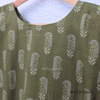 Olive green Cotton Silk churidar set with printed motifs, embroidered floral hem and cream-and-olive printed dupatta.