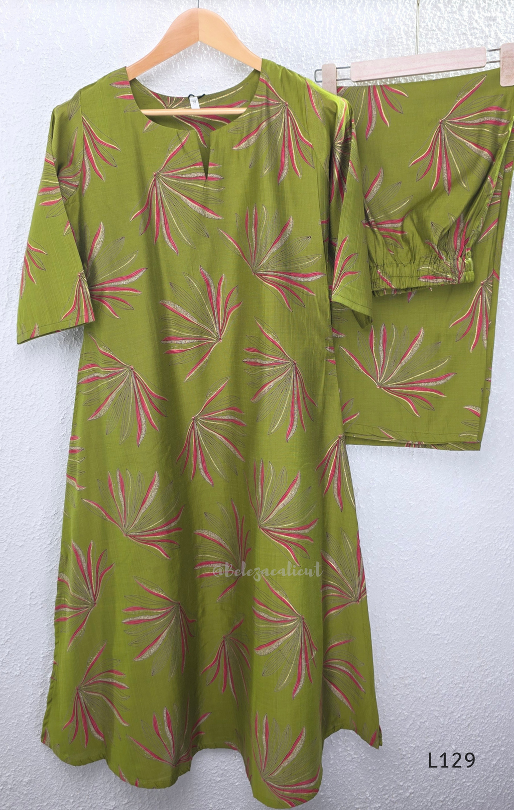 Olive green silk blend 2-piece kurti set with pink and beige leaf print, short sleeve A-line kurti and matching straight pant.