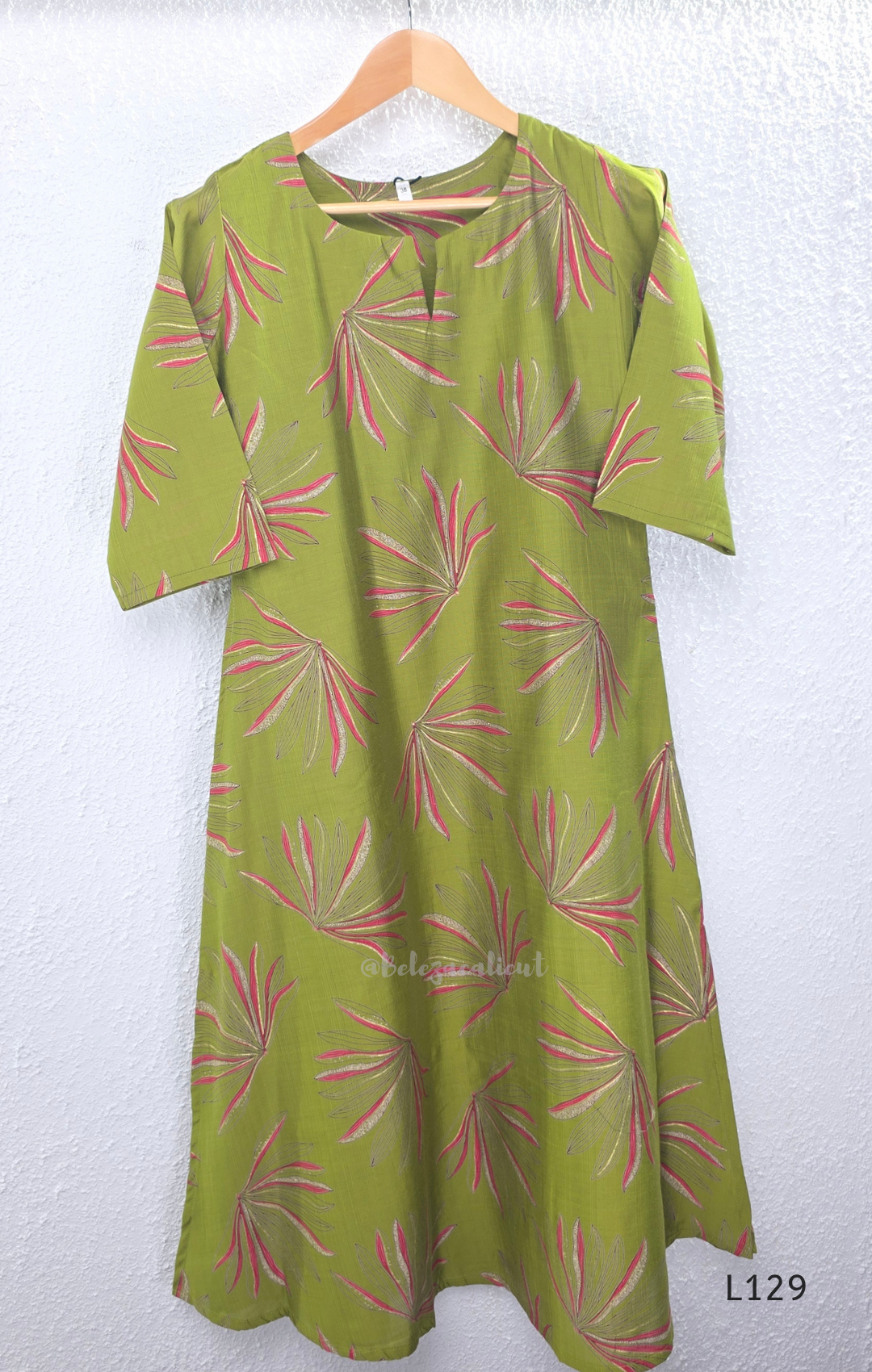 Olive green silk blend 2-piece kurti set with pink and beige leaf print, short sleeve A-line kurti and matching straight pant.