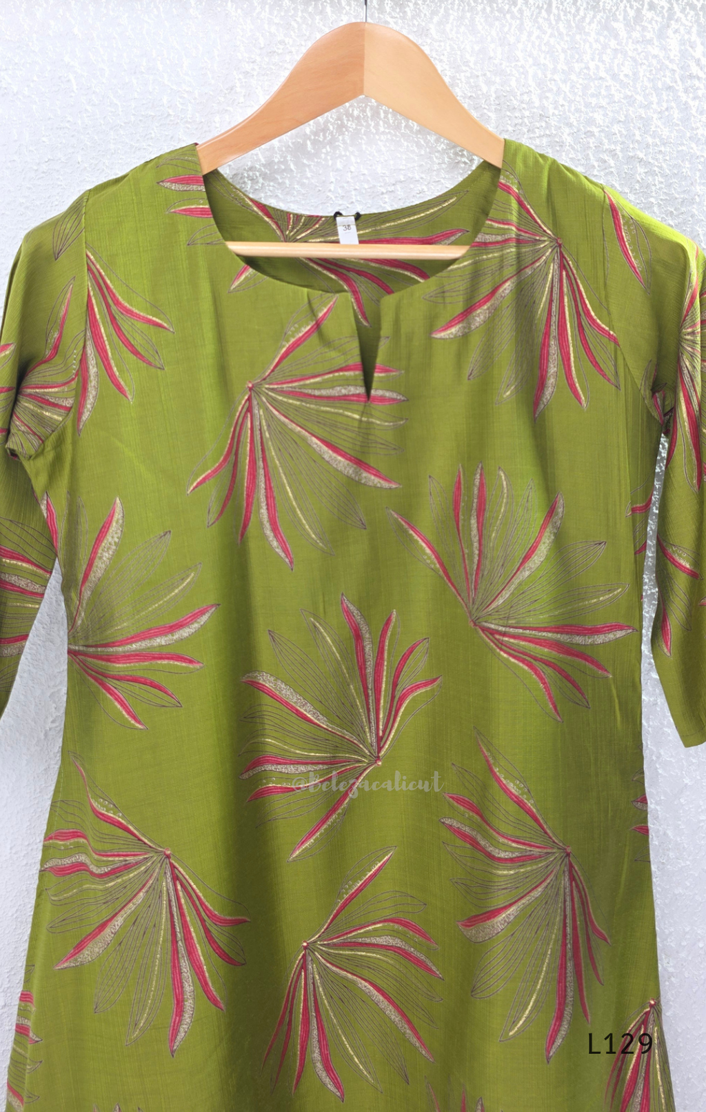 Olive green silk blend 2-piece kurti set with pink and beige leaf print, short sleeve A-line kurti and matching straight pant.