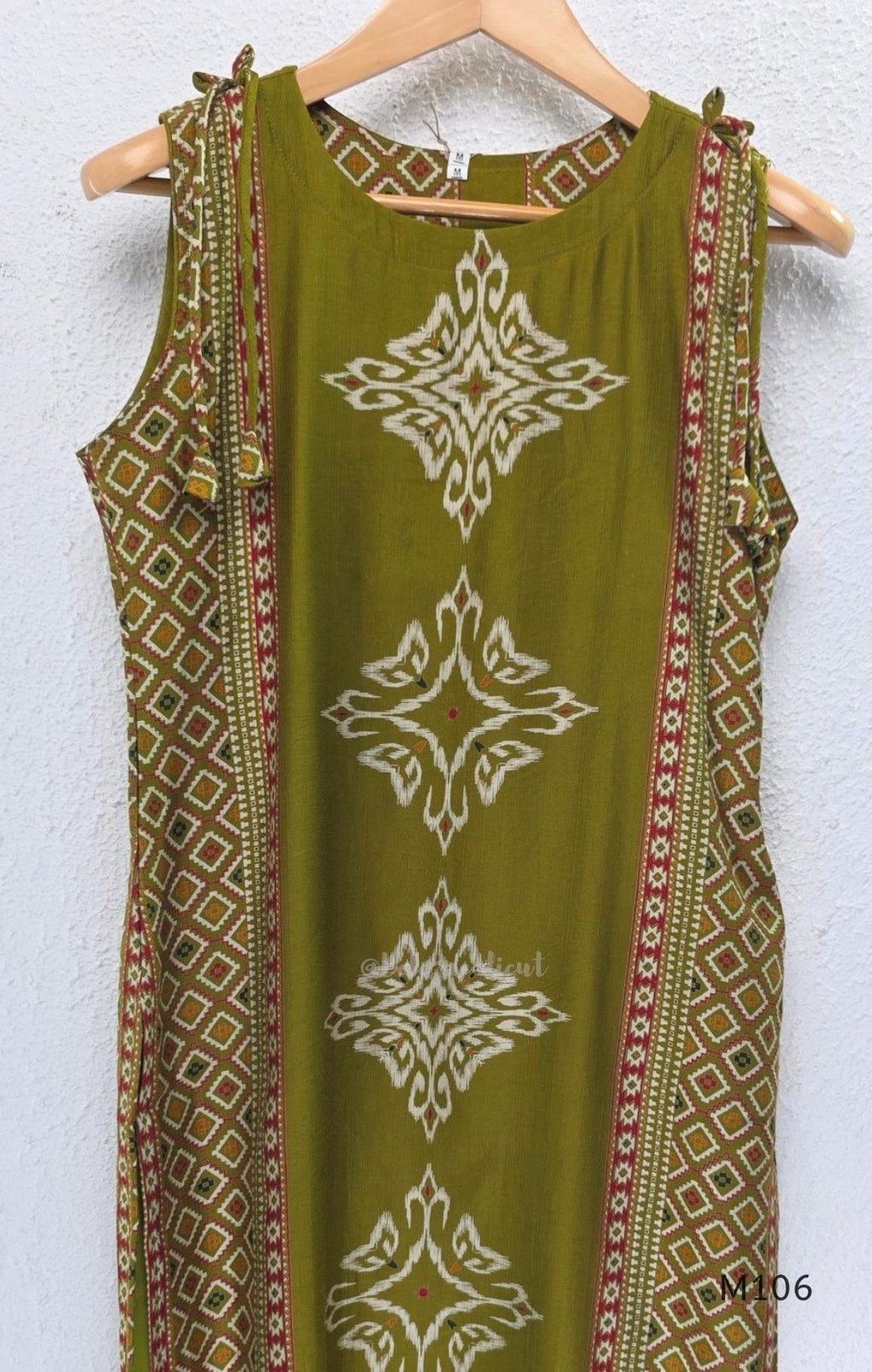 Olive green vertigan silk 2-piece set with straight kurta, white motif work, printed border panels and matching bottom.