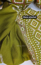 Olive green vertigan silk 2-piece set with straight kurta, white motif work, printed border panels and matching bottom.