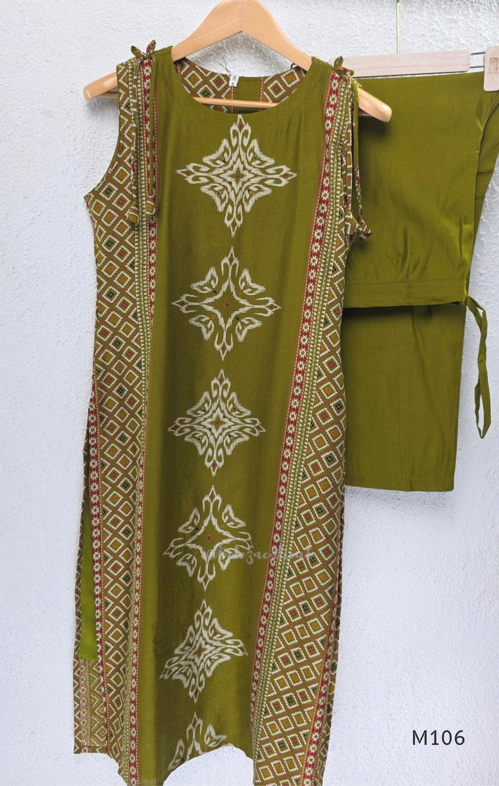 Olive green vertigan silk 2-piece set with straight kurta, white motif work, printed border panels and matching bottom.