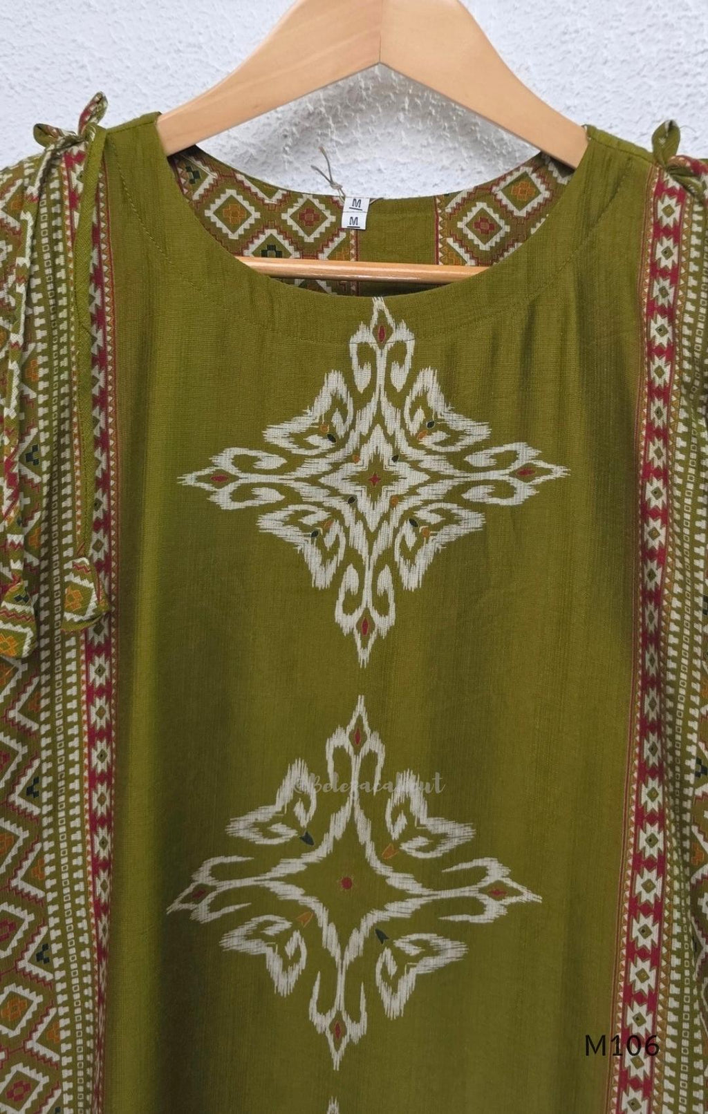 Olive green vertigan silk 2-piece set with straight kurta, white motif work, printed border panels and matching bottom.