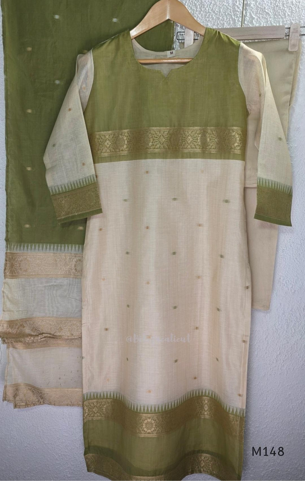 Olive green and ivory tissue blend churidar set with gold woven borders, scattered motifs, straight bottom and matching dupatta.