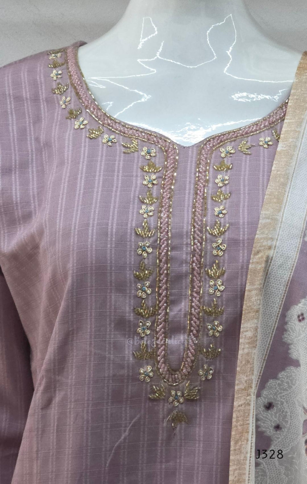 Onion mauve cotton churidar set Kerala with checked kurti, beadwork neckline, matching bottom, and cream floral printed dupatta with beige border.
