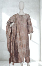 Mannequin wearing a patterned dress with a shawl against a white background