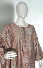 Mannequin wearing a patterned brown dress against a white background