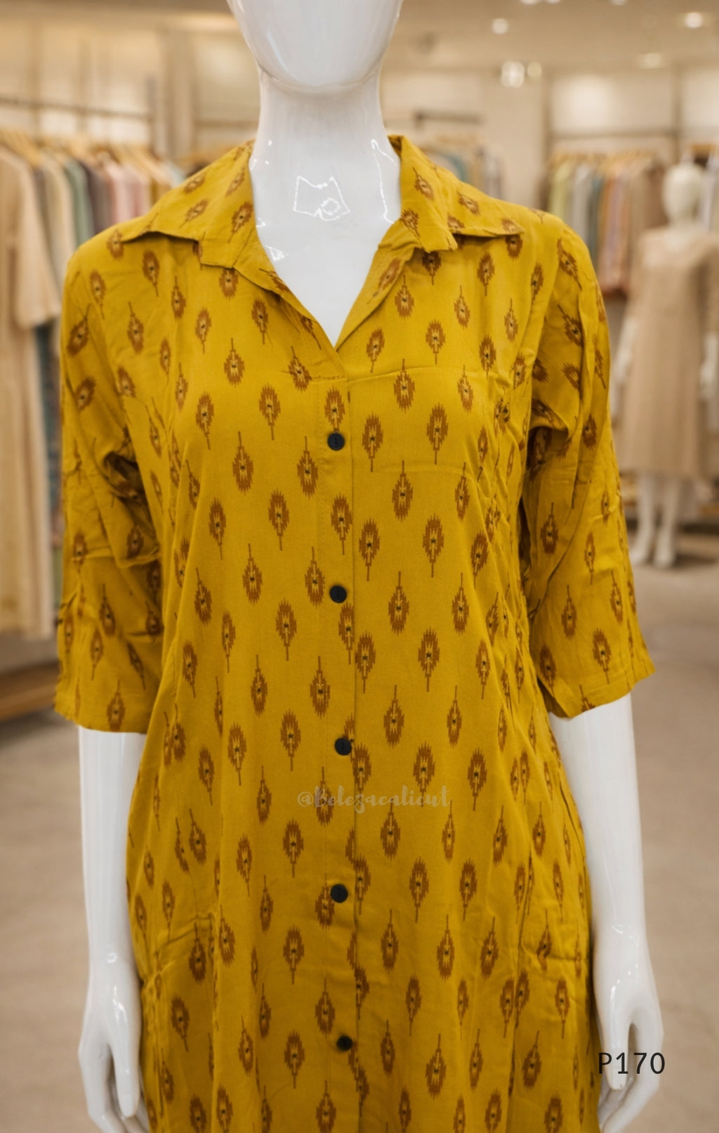 Yellow patterned dress on a mannequin in a store setting