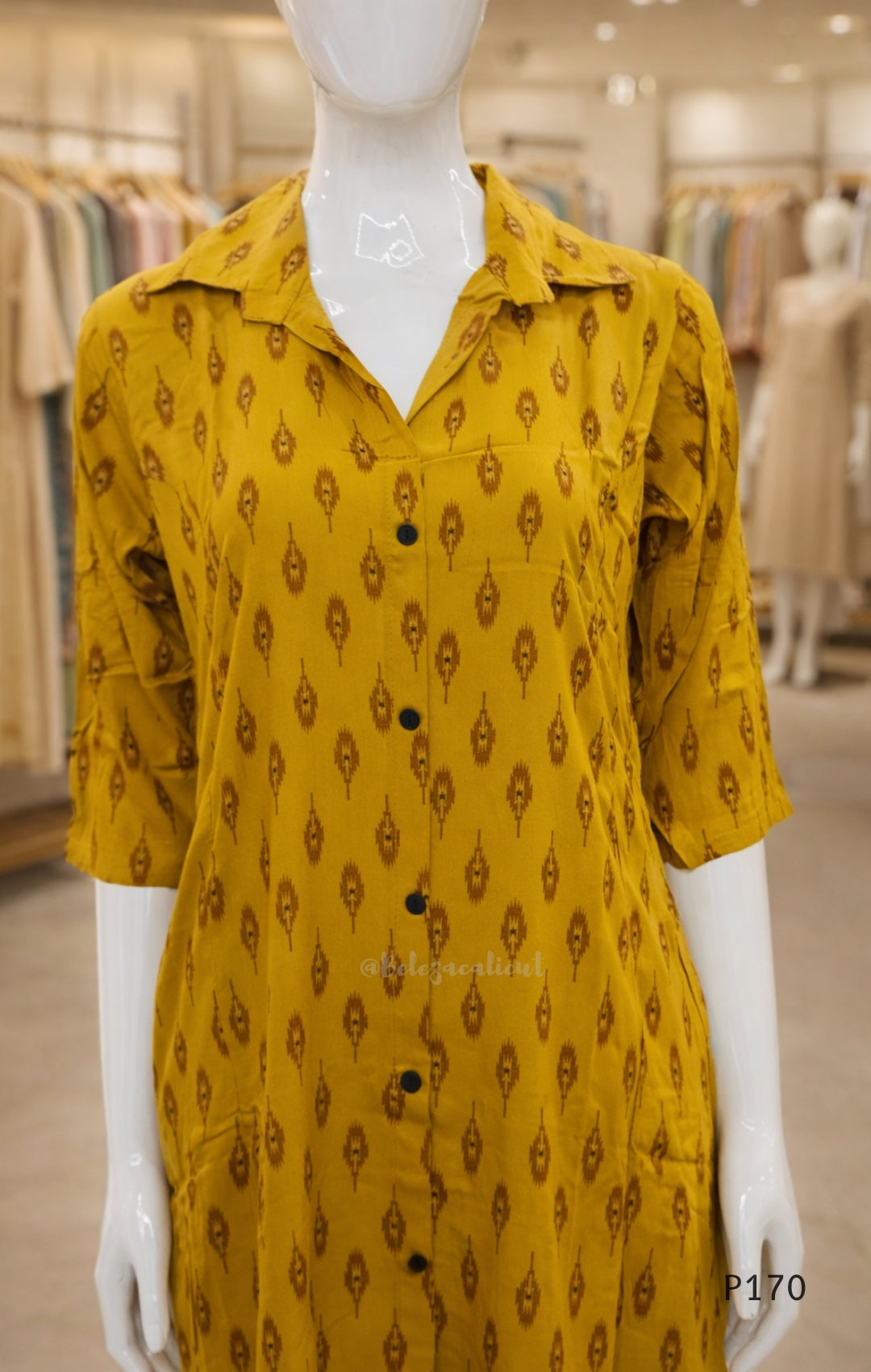 Yellow patterned dress on a mannequin in a store setting
