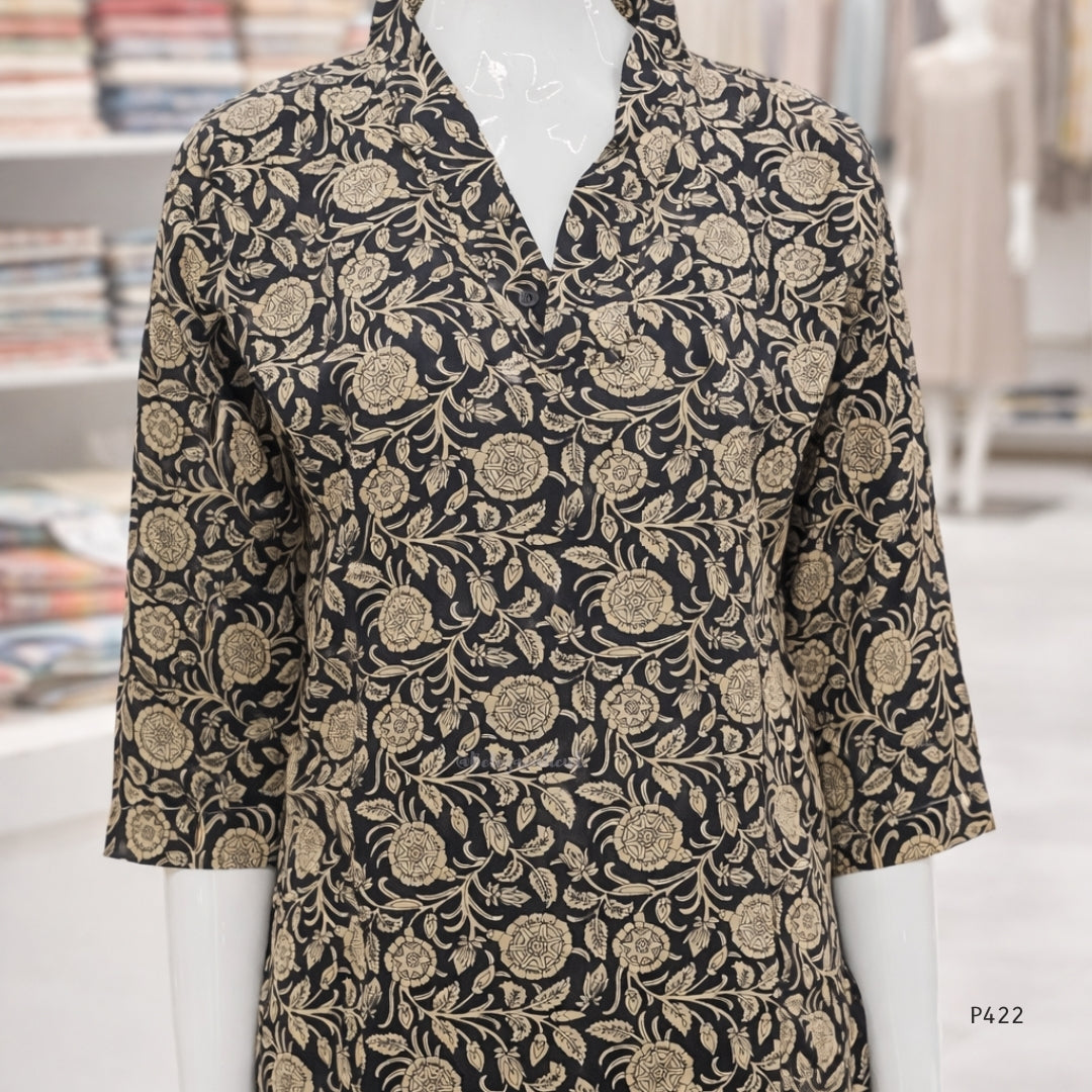 Black floral patterned shirt on a mannequin with a blurred indoor background
