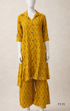 Mustard yellow outfit with a pattern on a mannequin against a beige background