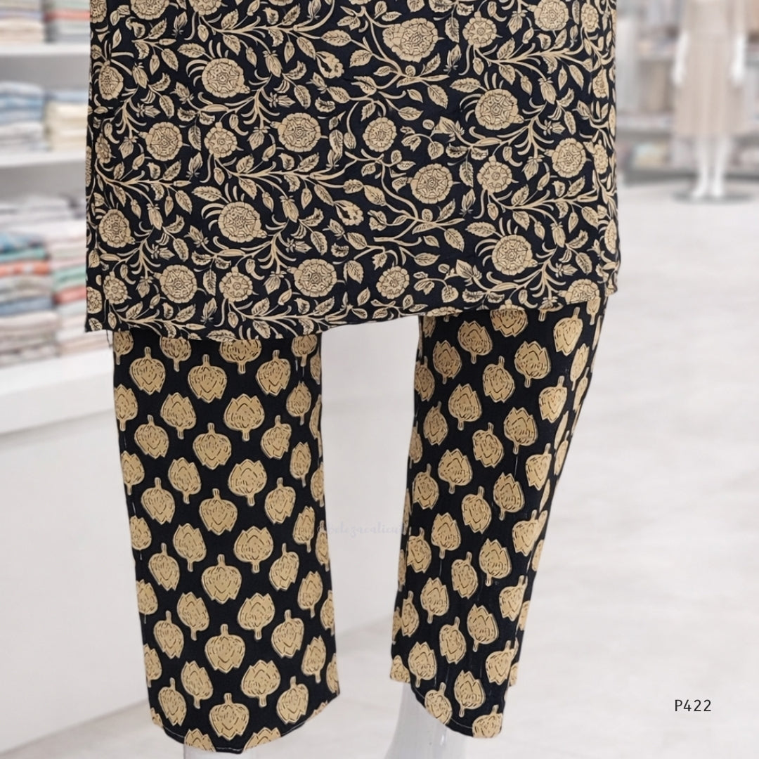 Black pants with gold floral pattern on a white background