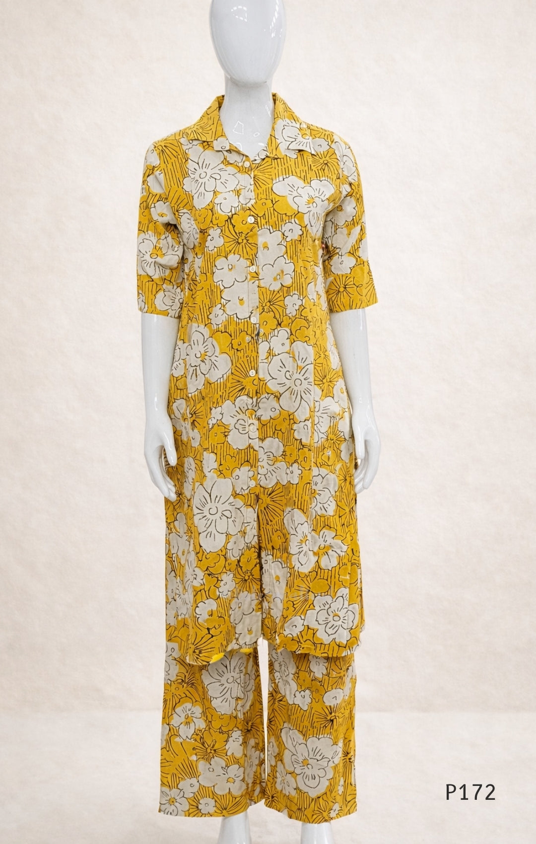 Mannequin wearing a yellow floral outfit on a white background