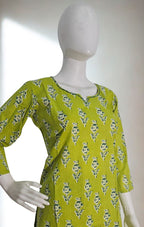 Green floral dress on a mannequin against a white background