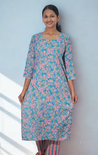 Woman wearing a floral kurta with a light blue background