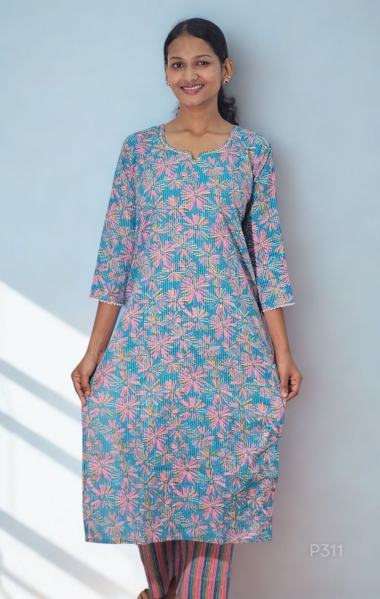 Woman wearing a floral kurta with a light blue background