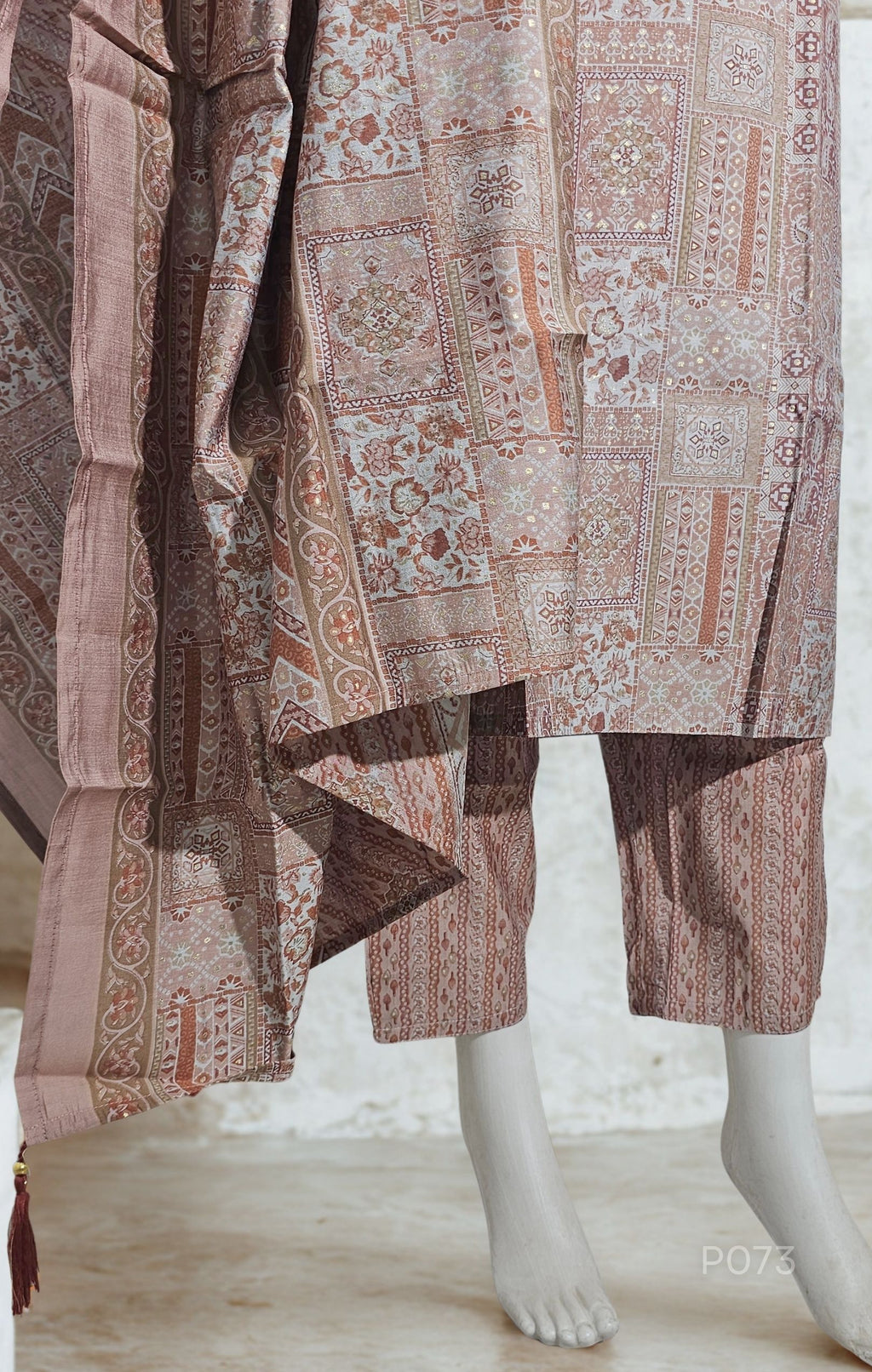 Traditional patterned fabric draped over a mannequin on a light background