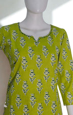 Green patterned top on a mannequin against a white background