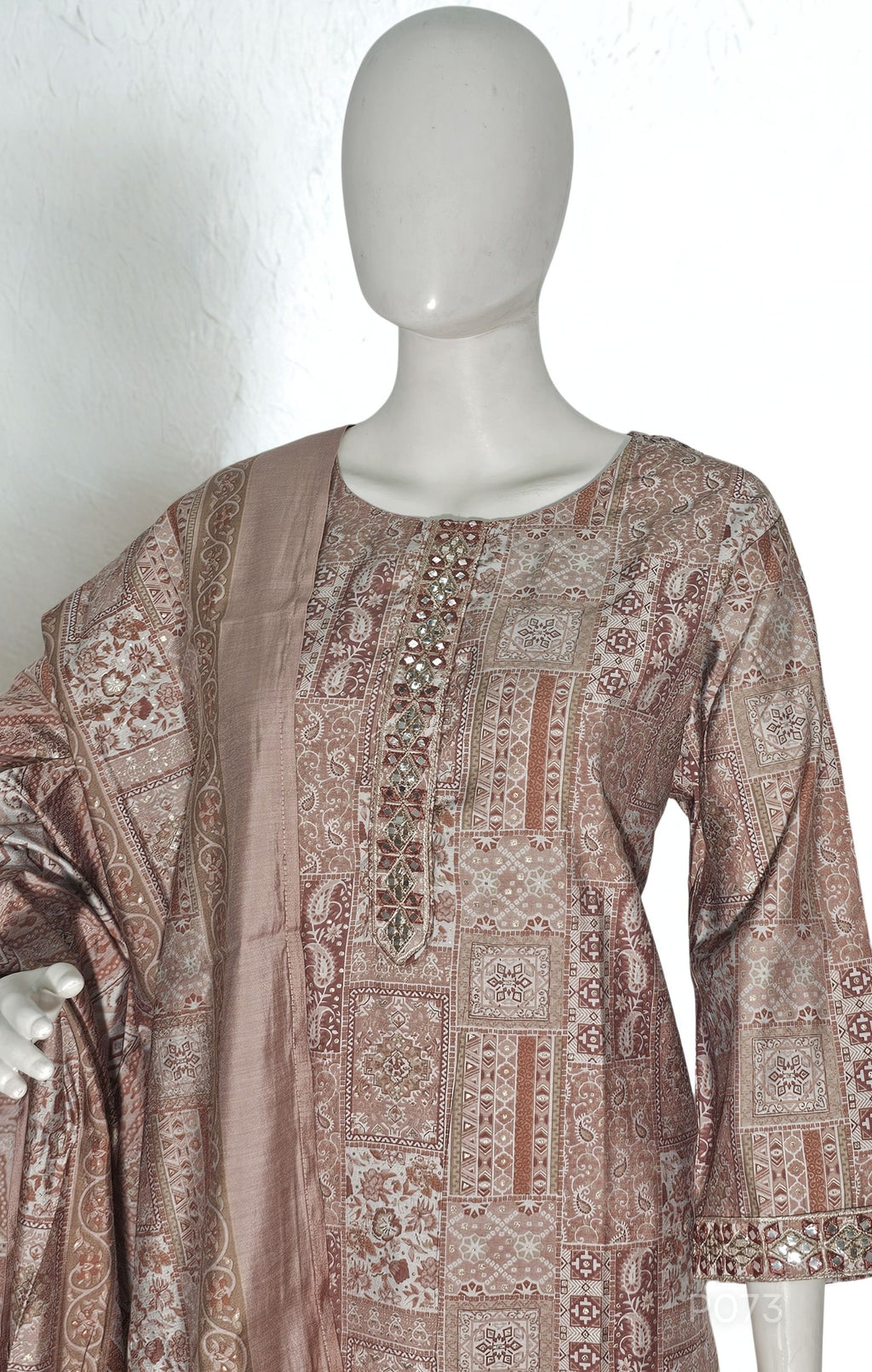 Mannequin wearing a patterned dress with a plain background