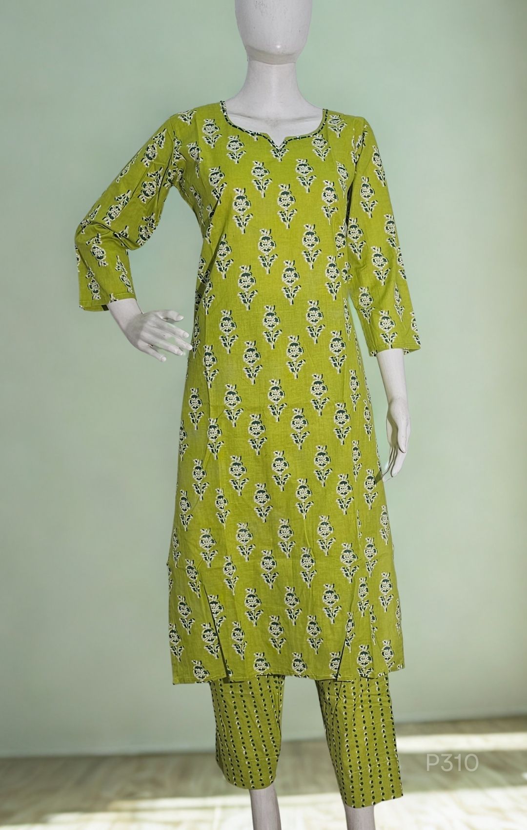 Green patterned kurta set on a mannequin against a light green background