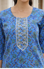 Blue floral patterned top with intricate white embroidery