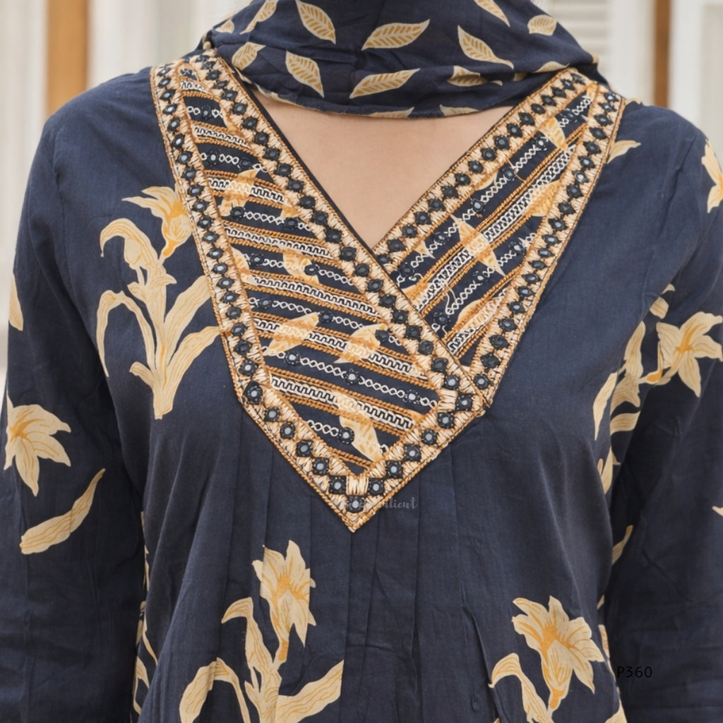 black garment with gold floral patterns and intricate beadwork