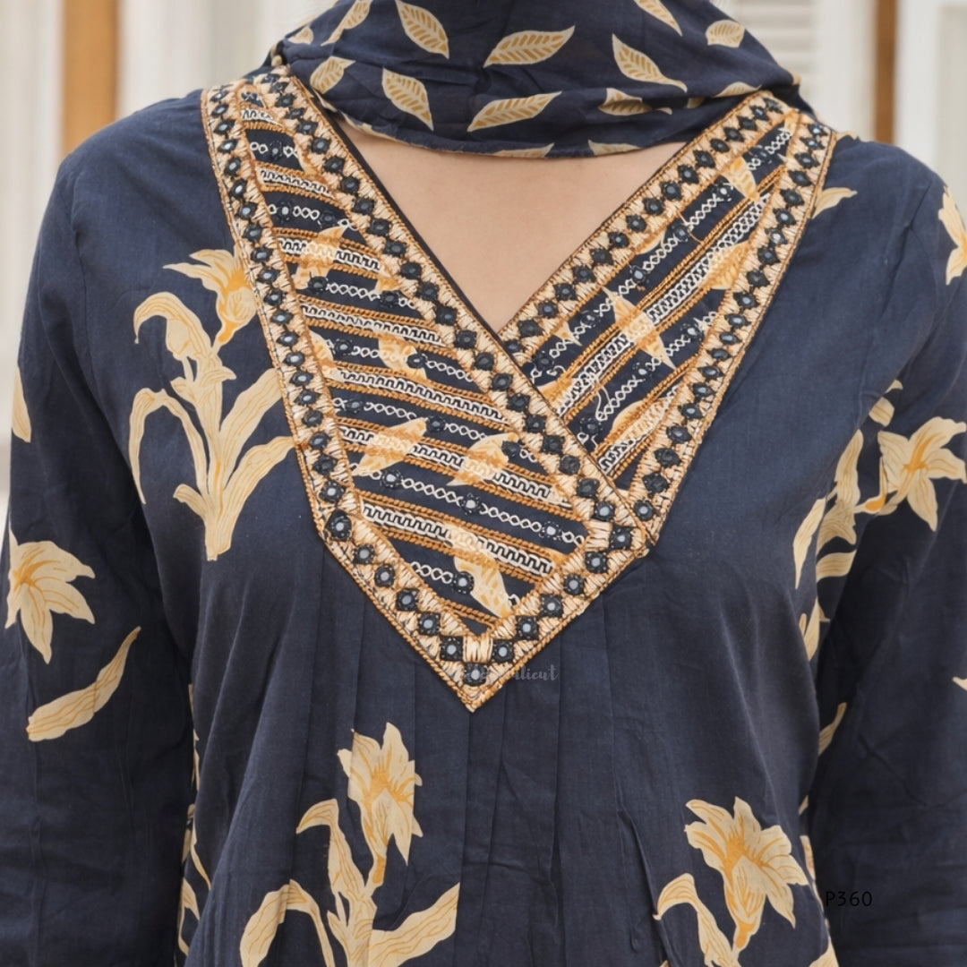 black garment with gold floral patterns and intricate beadwork