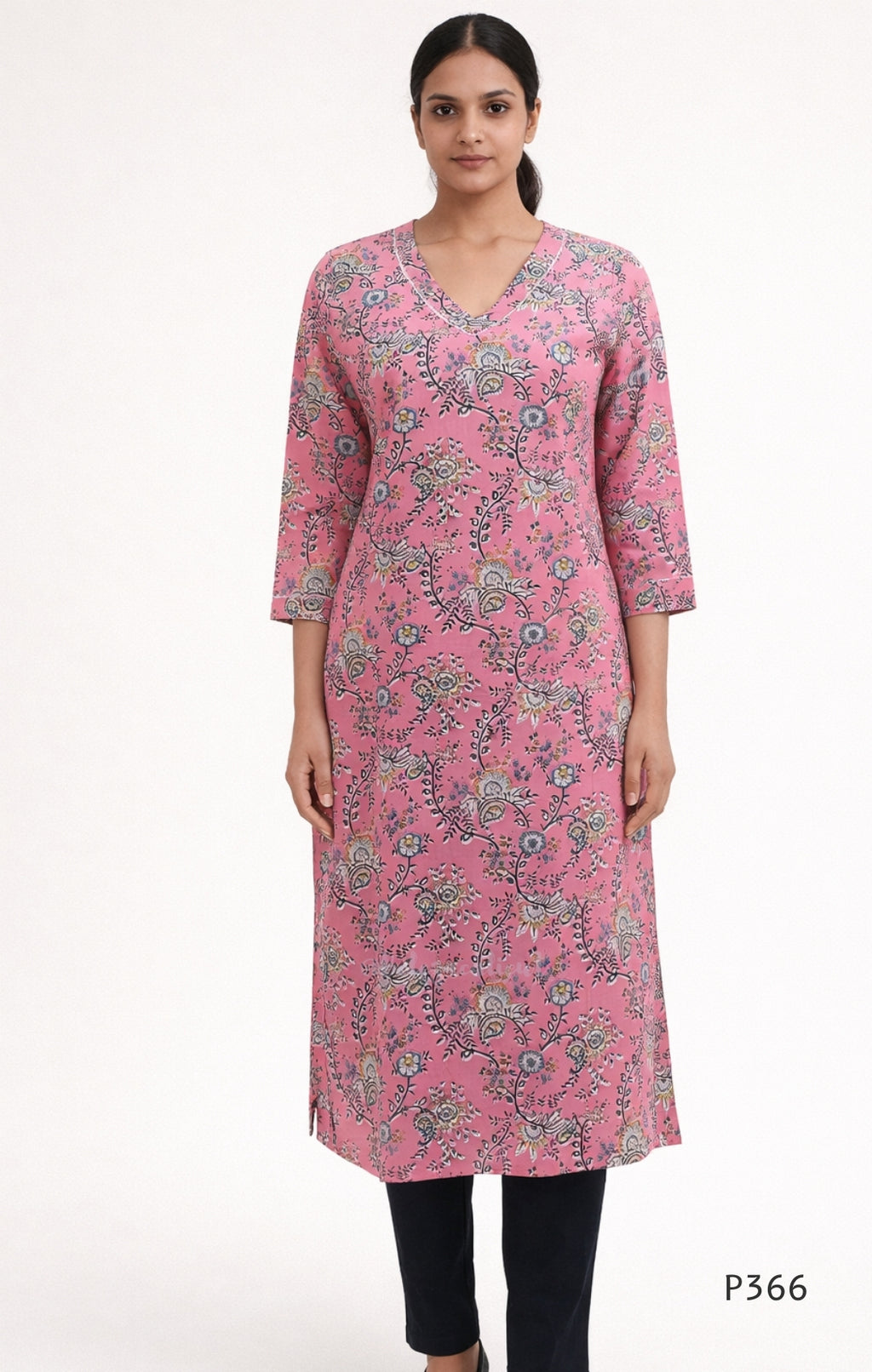 Woman wearing a pink floral kurta with black pants on a white background