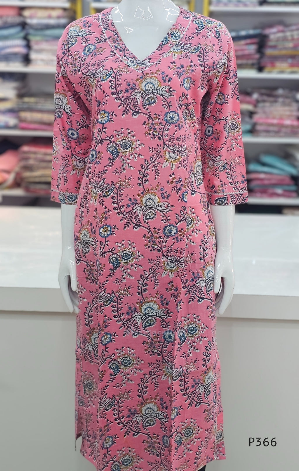 Pink floral dress on a mannequin in a store setting