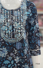 Blue and black floral embroidered dress on a mannequin with a blurred background