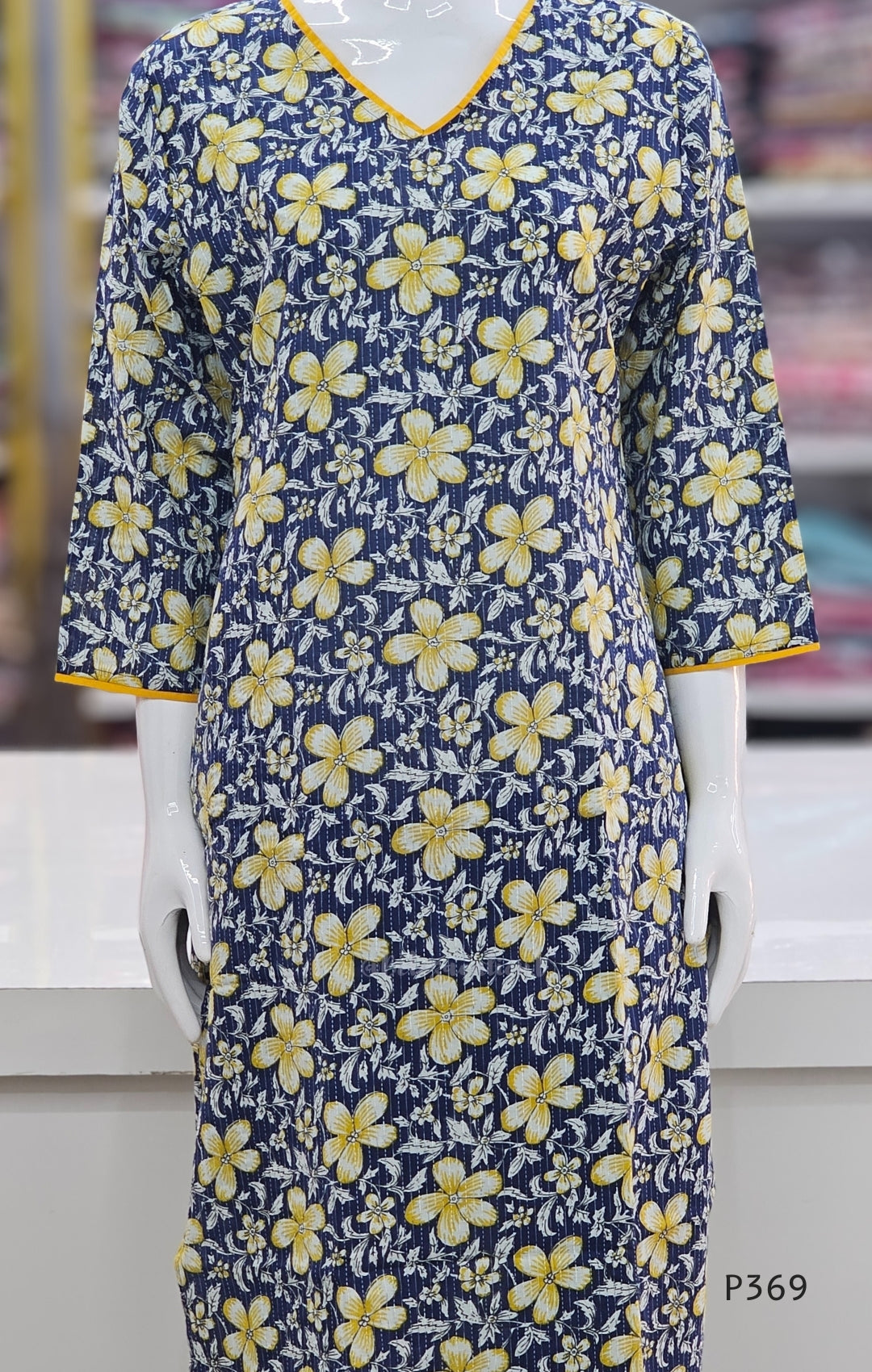 Blue dress with yellow floral pattern on a mannequin