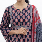 Woman wearing a navy blue patterned kurta with a red and white dupatta on a white background